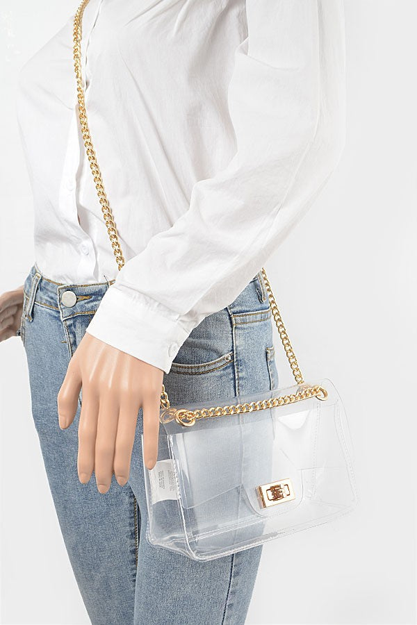 Transparent flap crossbody bag with gold chain shown on model